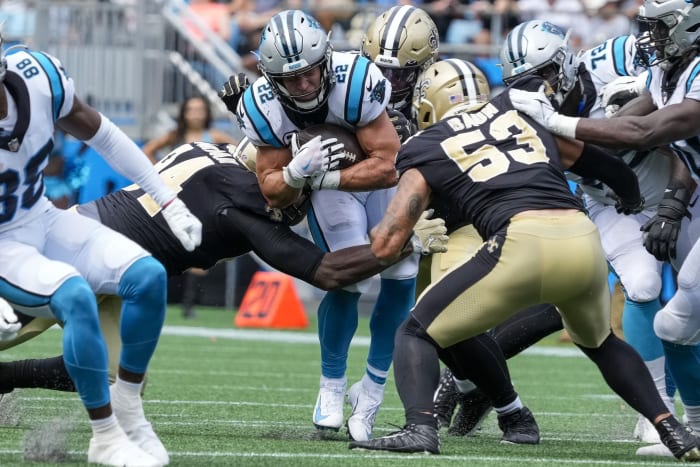 Carolina Panthers running back Christian McCaffrey (22) is tackled by the New Orleans Saints defense. Mandatory Credit: Jim Dedmon-USA TODAY Sports